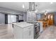 Bright, open kitchen featuring a large island with a cooktop and stainless steel vent hood at 806 N Central Ave, Locust, NC 28097