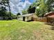 Home's backyard featuring a wooden fence and ample green space at 820 Kerley Ct, Statesville, NC 28677
