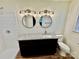 Updated bathroom featuring a modern vanity with granite top, dual mirrors, and tiled shower at 820 Kerley Ct, Statesville, NC 28677