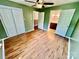 Spacious bedroom featuring wood-look flooring, ceiling fan, and ensuite access at 820 Kerley Ct, Statesville, NC 28677