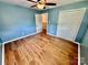 Cozy bedroom with wood-look flooring, ceiling fan, and ample closet space at 820 Kerley Ct, Statesville, NC 28677