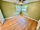 Inviting bedroom with hardwood floors, natural lighting, and a ceiling fan at 820 Kerley Ct, Statesville, NC 28677