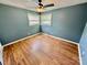 Well-lit bedroom features wood-look flooring, natural light from windows and neutral walls at 820 Kerley Ct, Statesville, NC 28677