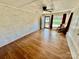 Inviting living room with wood-look flooring, painted brick wall, and a ceiling fan at 820 Kerley Ct, Statesville, NC 28677