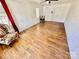 Living room featuring wood-look floors, white brick wall, and a floral accent chair at 820 Kerley Ct, Statesville, NC 28677