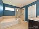 Bathroom features a soaking tub, separate shower, and modern finishes, offering a spa-like experience at 9027 Gray Willow Rd, Charlotte, NC 28227