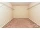 Walk-in closet features neutral carpet and wire shelving offering ample storage space at 9027 Gray Willow Rd, Charlotte, NC 28227