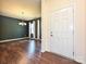 Dining room with dark grey walls, hardwood floors, and chandelier at 9027 Gray Willow Rd, Charlotte, NC 28227