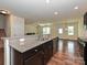 Kitchen island with granite countertops and a view into the living area at 9027 Gray Willow Rd, Charlotte, NC 28227