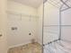 Laundry room includes a utility sink hook-up, wire shelving, and tile floors at 9027 Gray Willow Rd, Charlotte, NC 28227