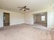 Open-concept living room with neutral carpet providing a versatile living space at 9027 Gray Willow Rd, Charlotte, NC 28227