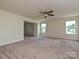 Spacious living room with ceiling fan and lots of natural light from the two windows at 9027 Gray Willow Rd, Charlotte, NC 28227