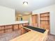 Office/study featuring built-in bookshelves, wooden desk, and neutral carpet at 9027 Gray Willow Rd, Charlotte, NC 28227