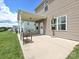 Covered patio featuring neutral flooring, a table, and a view of the backyard at 9027 Gray Willow Rd, Charlotte, NC 28227