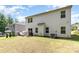 A fenced backyard featuring a patio, grill, modern chairs, and lush landscaping, perfect for outdoor enjoyment at 941 Rachel Anne Dr, Belmont, NC 28012