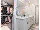 Bathroom with dual sinks, large mirror, and walk-in closet to show spaciousness and storage at 941 Rachel Anne Dr, Belmont, NC 28012