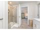 Clean bathroom featuring tile floors, glass enclosed shower and view to main bedroom with carpeted floor at 941 Rachel Anne Dr, Belmont, NC 28012