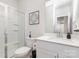 Modern bathroom with a glass-enclosed shower, white cabinets, and quartz countertop at 941 Rachel Anne Dr, Belmont, NC 28012