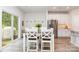 Bright dining area with sliding glass doors and stainless steel refrigerator in kitchen at 941 Rachel Anne Dr, Belmont, NC 28012