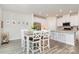 Bright dining area adjacent to kitchen with white cabinets, stainless appliances, and quartz counters at 941 Rachel Anne Dr, Belmont, NC 28012