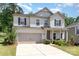 Charming two-story home with a two-car garage, manicured lawn, and inviting front porch with supporting columns at 941 Rachel Anne Dr, Belmont, NC 28012