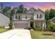 Inviting two-story home with a two-car garage, well-maintained lawn, and covered front porch during dusk at 941 Rachel Anne Dr, Belmont, NC 28012