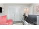 Home office featuring dual monitors, pink chair and white doors leading to a closet at 941 Rachel Anne Dr, Belmont, NC 28012