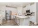 Modern kitchen with white cabinets, stainless steel appliances, quartz countertops, and barstool seating at 941 Rachel Anne Dr, Belmont, NC 28012