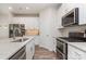 Contemporary kitchen with white cabinets, stainless steel appliances, quartz countertops, and stylish fixtures at 941 Rachel Anne Dr, Belmont, NC 28012