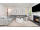 Open living room with fireplace, cozy sectional sofa, neutral colors, and lots of natural light at 941 Rachel Anne Dr, Belmont, NC 28012
