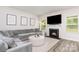 Comfortable living room with fireplace, large gray sectional sofa, neutral paint, and lots of natural light at 941 Rachel Anne Dr, Belmont, NC 28012