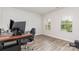 Home office with a dark wood desk, ergonomic chair, and natural light from two windows at 941 Rachel Anne Dr, Belmont, NC 28012