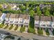 An aerial view of modern townhomes with individual driveways in a well-maintained residential neighborhood at 9775 Mallard Glen Dr, Charlotte, NC 28262