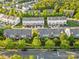 An aerial view of colorful townhomes with tree-lined streets in a well-manicured community on a sunny day at 9775 Mallard Glen Dr, Charlotte, NC 28262