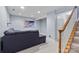 Finished basement with a gray couch, carpet, and stairs at 9775 Mallard Glen Dr, Charlotte, NC 28262