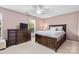 Comfortable bedroom with a ceiling fan and bright windows provides a relaxing personal space at 9775 Mallard Glen Dr, Charlotte, NC 28262