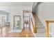 Spacious foyer with hardwood floors, staircase, and stylish mirror at 9775 Mallard Glen Dr, Charlotte, NC 28262