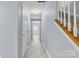 Inviting hallway featuring neutral paint and staircase with wood and white railing at 9775 Mallard Glen Dr, Charlotte, NC 28262