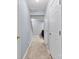 Hallway with neutral paint and tile flooring leading to carpeted area at 9775 Mallard Glen Dr, Charlotte, NC 28262