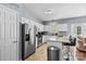 Well-lit kitchen with stainless steel refrigerator and a breakfast bar, open to the living space at 9775 Mallard Glen Dr, Charlotte, NC 28262