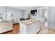 Kitchen island featuring granite countertops, white cabinetry, and proximity to the living area at 9775 Mallard Glen Dr, Charlotte, NC 28262