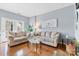 Comfortable living room featuring hardwood floors, neutral decor, and ample natural light at 9775 Mallard Glen Dr, Charlotte, NC 28262