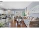 Inviting living room with hardwood floors, natural light, and a seamless connection to the kitchen at 9775 Mallard Glen Dr, Charlotte, NC 28262