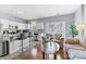 Bright living area with hardwood floors and an open layout, leading into the modern kitchen at 9775 Mallard Glen Dr, Charlotte, NC 28262