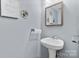 Powder room featuring pedestal sink, mirror, and light gray paint at 9775 Mallard Glen Dr, Charlotte, NC 28262