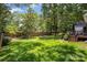 Expansive backyard with lush green grass, privacy fence, and mature trees for ultimate outdoor enjoyment at 1014 Covewood Ct, Charlotte, NC 28270