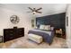 Primary bedroom featuring paneled wall, ceiling fan, and lots of natural light at 1014 Covewood Ct, Charlotte, NC 28270