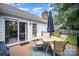 Outdoor deck features a patio dining set and umbrella for enjoying open air dining at 1014 Covewood Ct, Charlotte, NC 28270
