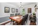 Elegant dining room with large wooden table, stylish decor, and ample natural light at 1014 Covewood Ct, Charlotte, NC 28270