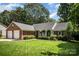 Charming brick home featuring a well-manicured lawn, attached garage, and cozy front porch at 1014 Covewood Ct, Charlotte, NC 28270